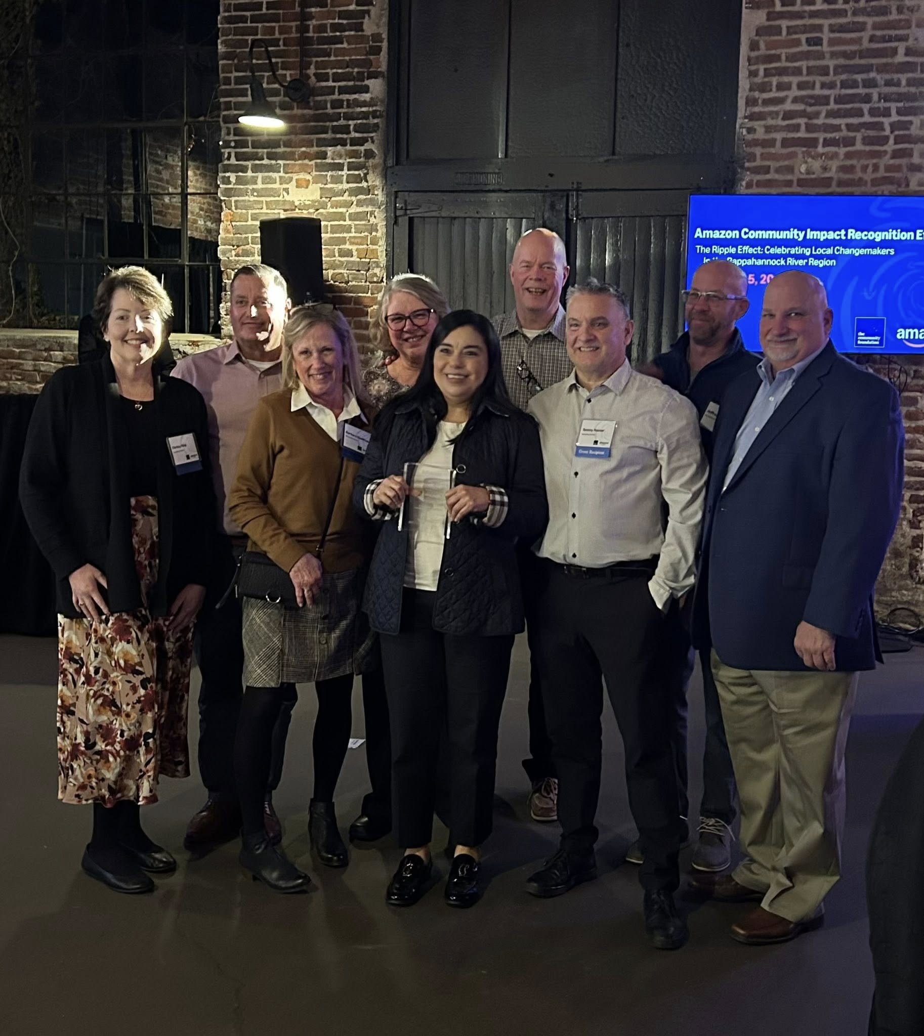 Spreading Smiles Community Impact Award Team holding certificate