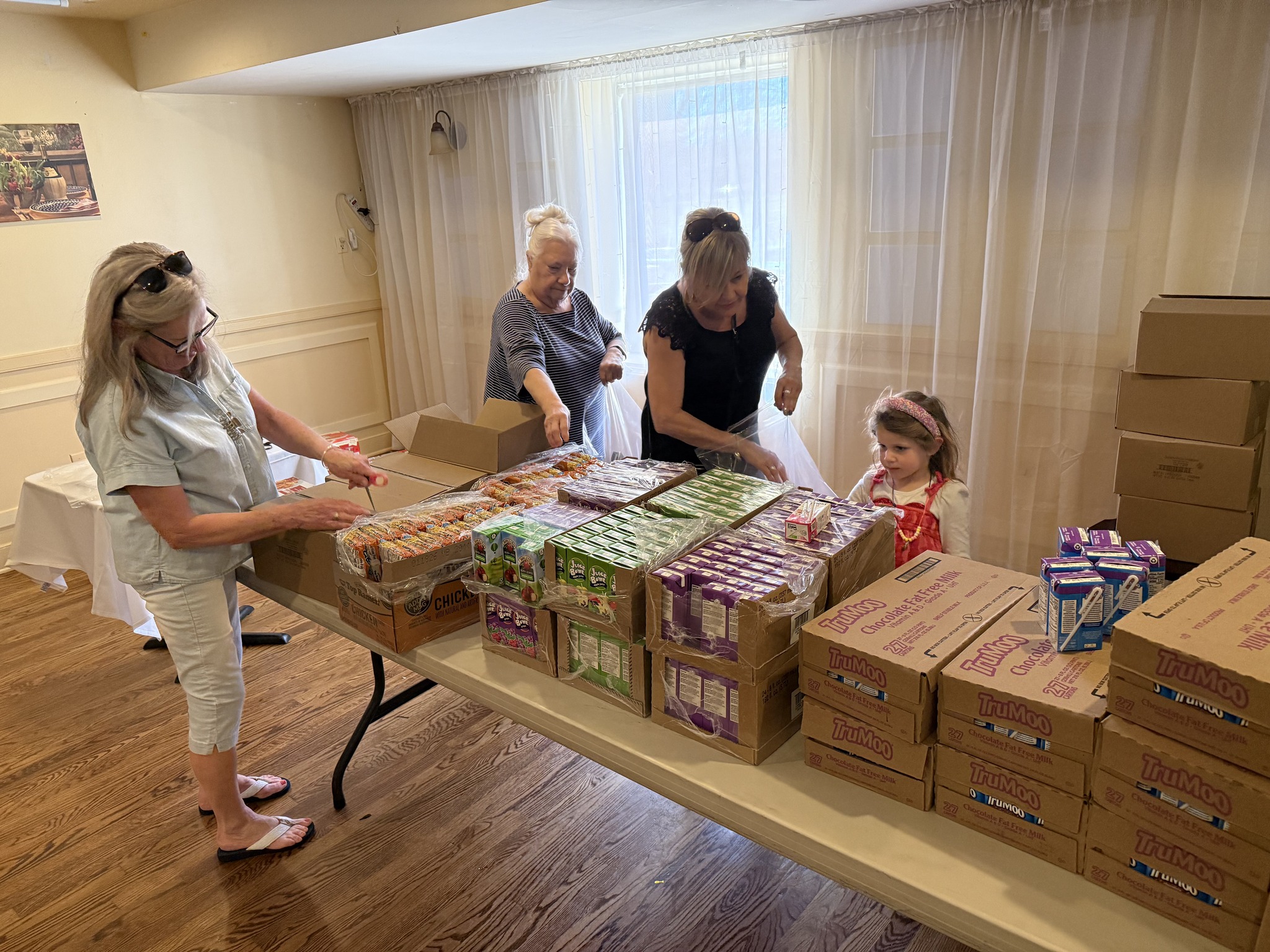 Spreading Smiles Volunteers happily packing food boxes